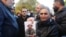 ARMENIA -- A woman holds a photograph of a serviceman who remains unaccounted for during a rally in Yerevan, November 24, 2020