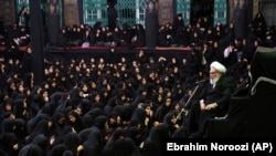 An Iranian Shi'ite cleric speaks to women mourners during the holy day of Ashura at the a mosque in Tehran in September 2018.