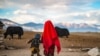 <p>Pamir Kyrgyz children at their nomadic camp in Afghanistan&rsquo;s Pamir Mountains. The boy&rsquo;s back is pinned with talismans in the belief they will protect his health in a land with rare&nbsp;access to medical care.</p>
<p>&nbsp;</p>
