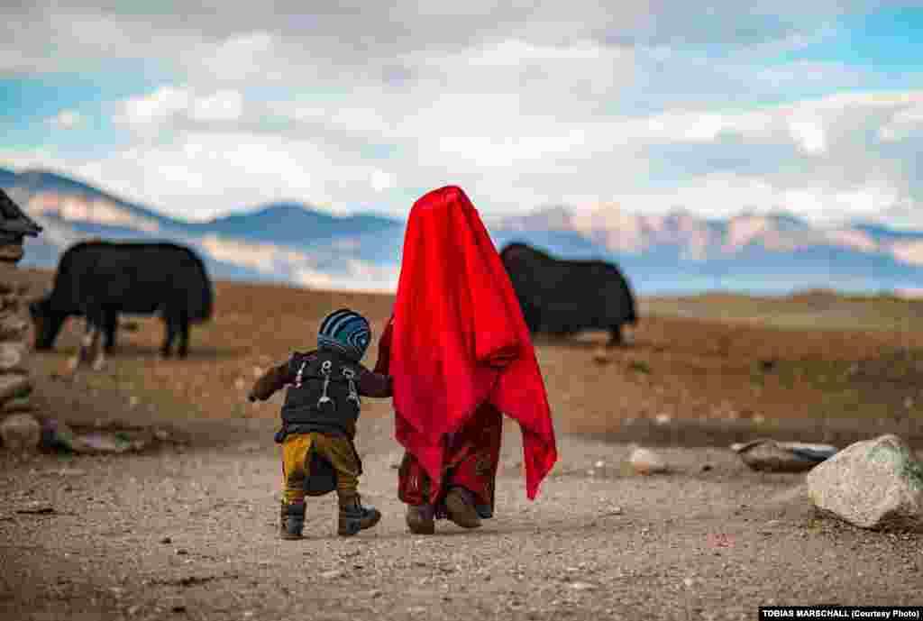 Pamir Kyrgyz children at their nomadic camp in Afghanistan&rsquo;s Pamir Mountains. The boy&rsquo;s back is pinned with talismans in the belief they will protect his health in a land with rare&nbsp;access to medical care. &nbsp; 