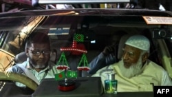 د جماعت اسلامي مشر شفیق الرحمان (ښي لوري ته) د فبرورۍ پر ۱۲مه په ډاکه کې له رسنیو سره تر خبرو وروسته په ګاډي کې روان دی.