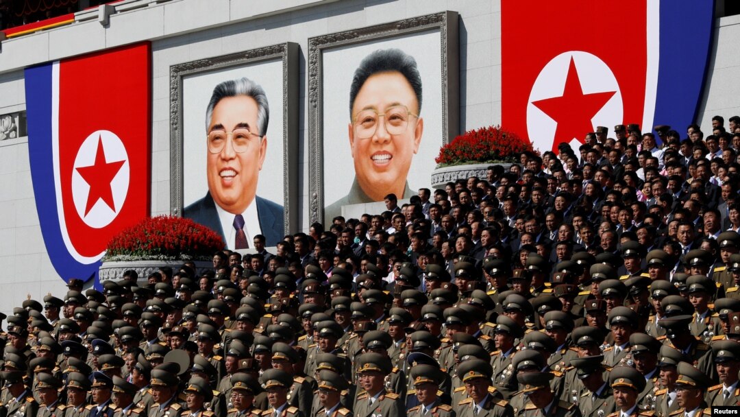 Military officers stand near portraits of North Korean founder Kim Il Sung (left) and late leader Kim Jong Il during a military parade marking the 70th anniversary of North Korea's foundation in Pyongyang on September 9.
