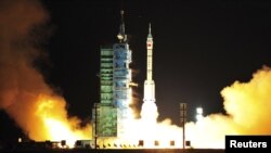 A modified model of the Long March CZ-2F rocket carrying the unmanned spacecraft Shenzhou 8 blasts off from the launch pad at the Jiuquan Satellite Launch Center in China's northwest Gansu Province in November.