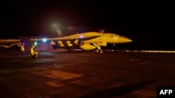 Photo provided by the US Central Command shows a jet preparing for the latest wave of strikes on strategic Iranian sites.