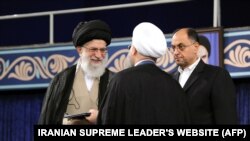 Vahid Haqqanian seen next to the Supreme Leader in Rouhani's inauguration.