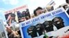 Demonstrators, including former interpreters for the British Army in Afghanistan, hold placards as they protest outside the Houses of Parliament in London on August 18, 2021, following the withdrawal of troops and the resumption of power by the Taliban in Kabul.