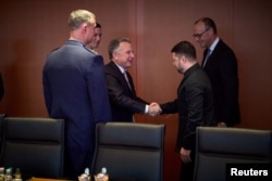 Президент України Володимир Зеленський тисне руку спецпредставнику США Стіву Віткоффу, поруч – зять президента США Джаред Кушнер, канцлер Німеччини Фрідріх Мерц та генерал ВПС США, командувач Об'єднаних сил НАТО Алексус Гринкевич, Берлін, Німеччина, 14 грудня 2025 року