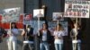 Armenia - Members of the Founding Parliament opposition movement hold up pictures of its arrested leaders during a rally in Yerevan, 17Apr2015.