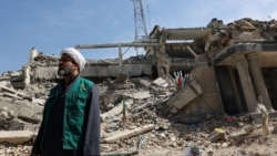 Әуе шабуылынан қираған полиция кеңсесі ғимаратының орнында тұрған адам. Иран, Тегеран, 4 наурыз, 2026 жыл.