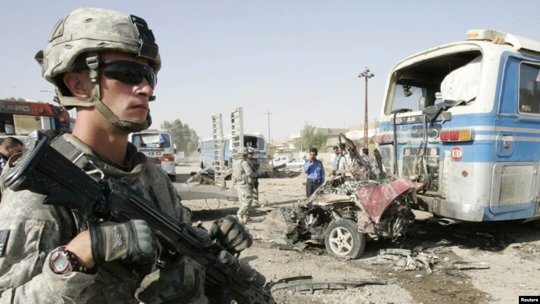 A U.S. soldier stands at the site of a bomb attack in Kirkuk on August 25. Continuing violence means the remaining 50,000 troops will still have much to do.