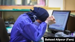 A nurse at a hospital in Hamedan, Iran, pauses for a moment while caring for patients with the coronavirus in April 2021.