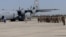 Armenia - Armenian troops board a U.S. military transport plane bound for Kosovo at Yerevan airport, 6Jul2012.