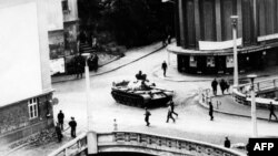 A tank drives on a street in the Czechoslovak city of Trutnov during confrontations between demonstrators and Warsaw Pact troops and tanks in August 1968.