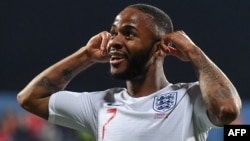England forward Raheem Sterling gestures toward Montenegrin fans who were making racist chants after he scored the fifth goal in his team's 5-1 victory over the Balkan nation in March.