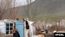 A Kazakh man lives in makeshift housing after fleeing floods earlier this spring. 