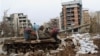 Children play on a damaged tank in front of a ruined building in Sarajevo's Kovacici district in February 1996. 