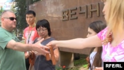 Pro-Russia activists hand out St. George Ribbons in Kazakhstan ahead of Victory Day celebrations on May 9.