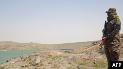 A Taliban guard near the Pashdan Dam after the inauguration of its power station in Herat Province on August 14