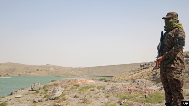 A Taliban guard near the Pashdan Dam after the inauguration of its power station in Herat Province on August 14