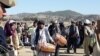 Afghan government officials meet with refugees from Waziristan in the Gulan camp on December 4.