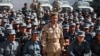 Afghan General Abdul Raziq (center), police chief of Kandahar, poses for a picture during a graduation ceremony at a police training center in Kandahar in February 2017.