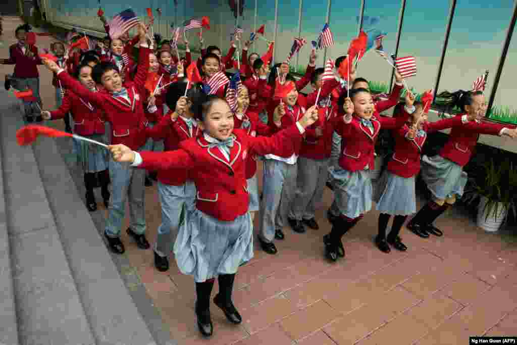 Students wave American and Chinese flags as they send off U.S. first lady Melania Trump and her Chinese counterpart Peng Liyuan after their visit to the Banchang Primary School in Beijing on November 9. (AFP/Ng Han Guan)