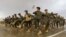 Afghan National Army (ANA) soldiers march during a training exercise of a graduation ceremony at a training center in the western Herat province on April 15.