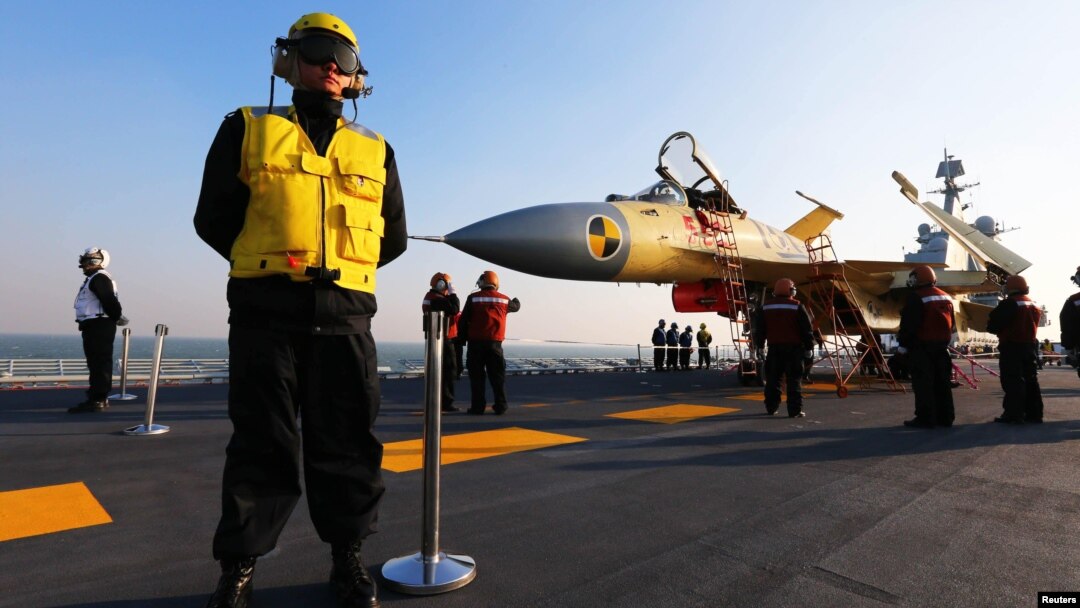 Chinese servicemen check a J-15 fighter jet on the Chinese aircraft carrier "Liaoning." (undated)