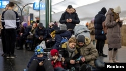 People take shelter inside a subway station during a barrage of Russian missiles in Kyiv on December 16.