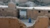 Afghanistan - An Afghan woman walks through an old city area of Ghazni province, 07Aug2007