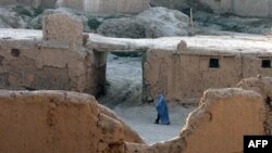 Afghanistan - An Afghan woman walks through an old city area of Ghazni province, 07Aug2007