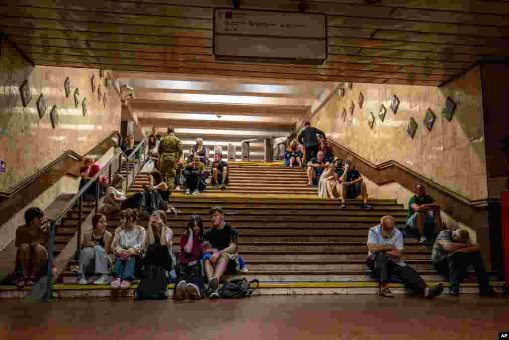 People rest in a metro station, being used as a bomb shelter, during a Russian drones attack in Kyiv.
