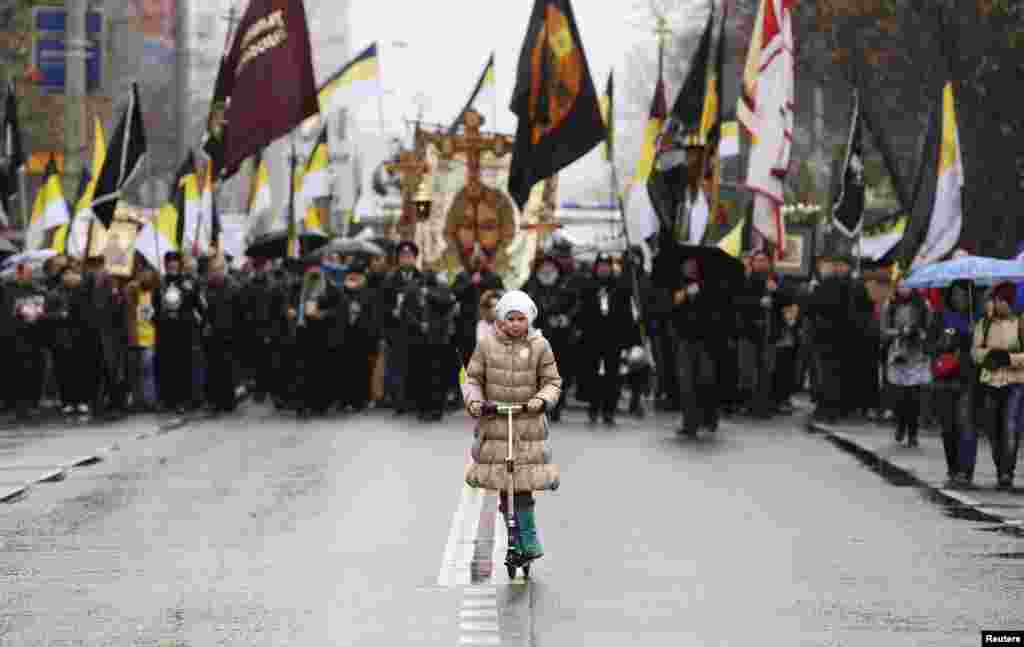 A girl rides a push scooter during a demonstration organized by Russian nationalists on National Unity Day in Moscow on November 4. (Reuters/Sergei Karpukhin)