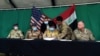 U.S. Brigadier General Vincent B. Barker (R) and Iraqi Staff Major General Mohammad Fadhel Abbas (2-R) attend the handover ceremony of Qayyarah Airfield West, 60km south of Mosul, March 26, 2020