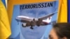 Перший рік війни Росії проти України. Зображення Володимира Путіна на плакаті учасників акції протесту в столиці Австралії через два дні після збитого 17 липня російськими гібридними силами на Донбасі «Боїнга», в результаті чого загинули 298 людей. Сідней, 19 липня 2014 року