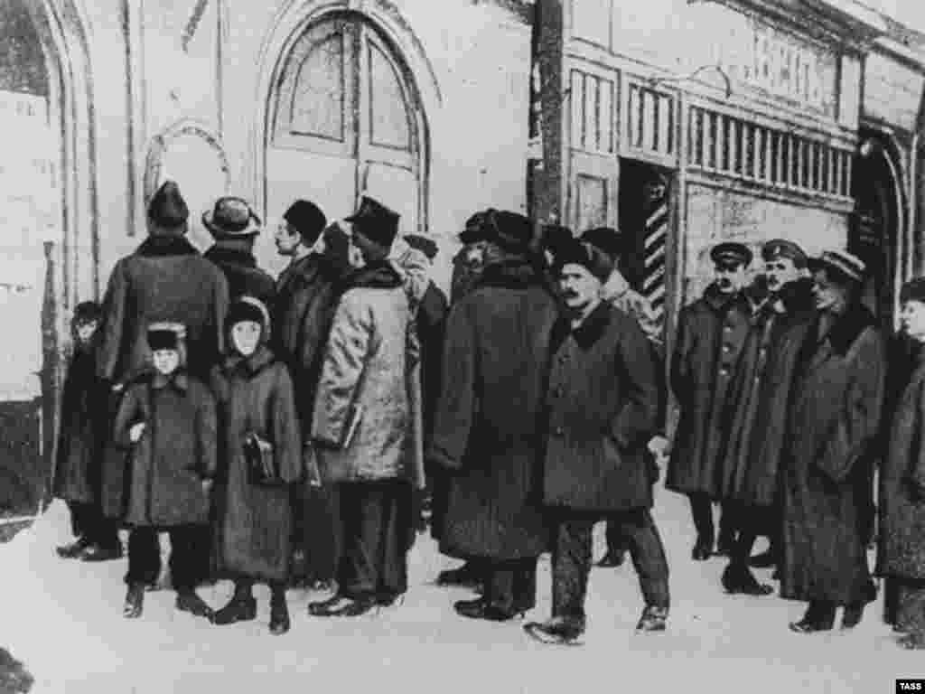 Petrograd residents read decrees posted by the new Soviet government in 1917 - In short order, the Bolsheviks issued decrees nationalizing banks, factories, and agricultural land. They negotiated a withdrawal from World War I in March 1918. They seized the property of the Russian Orthodox Church and cancelled the country's foreign debt. 