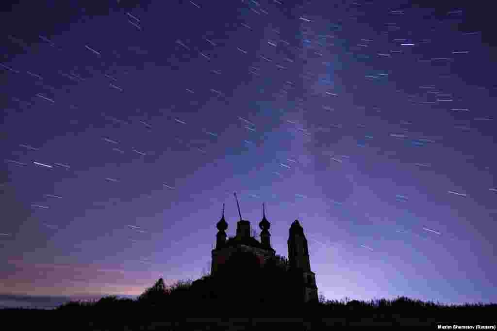 An abandoned church is seen under a starry sky outside of the settlement of Semibratovo, Yaroslavl region, Russia.