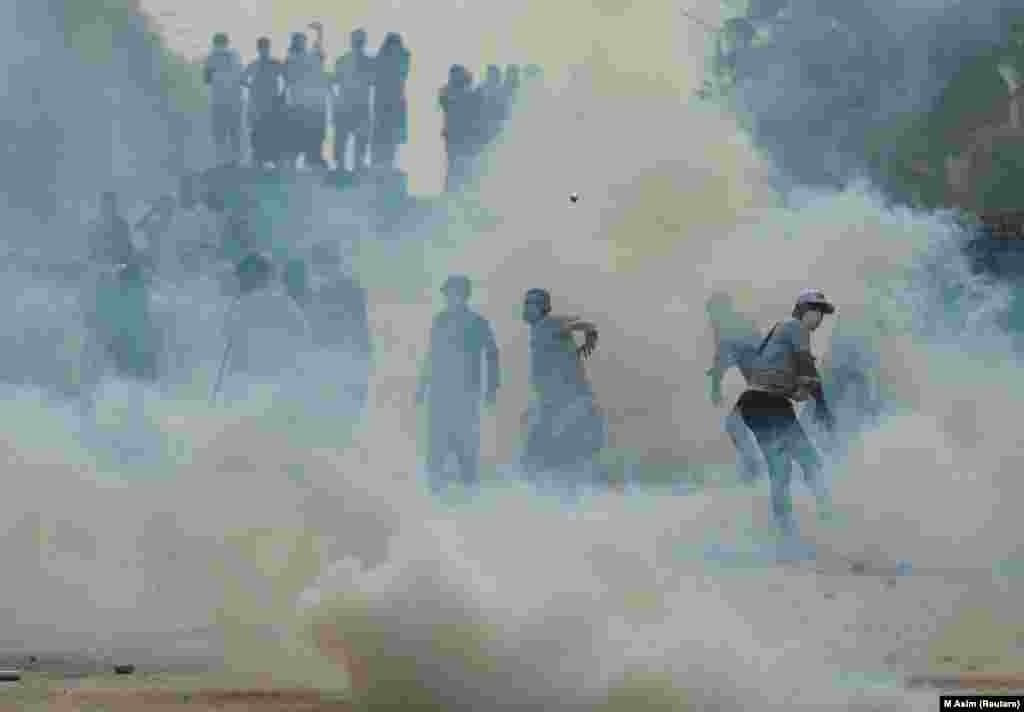 A supporter of jailed former Pakistani Prime Minister Imran Khan&#39;s party, Pakistan Tehrik-e Insaf, throws a tear-gas shell during an antigovernment rally in Islamabad.