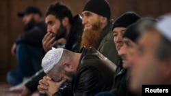 Crimean Tatars listen to a sermon in the Khan Chair mosque in Bakhchisaray, near Simferopol.