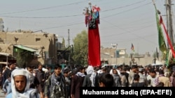 Afghan Shi'a devotees attend a mourning procession commemorating Ashura in Kandahar on September 20.