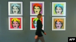 Kate Moss në fotografitë në mur.