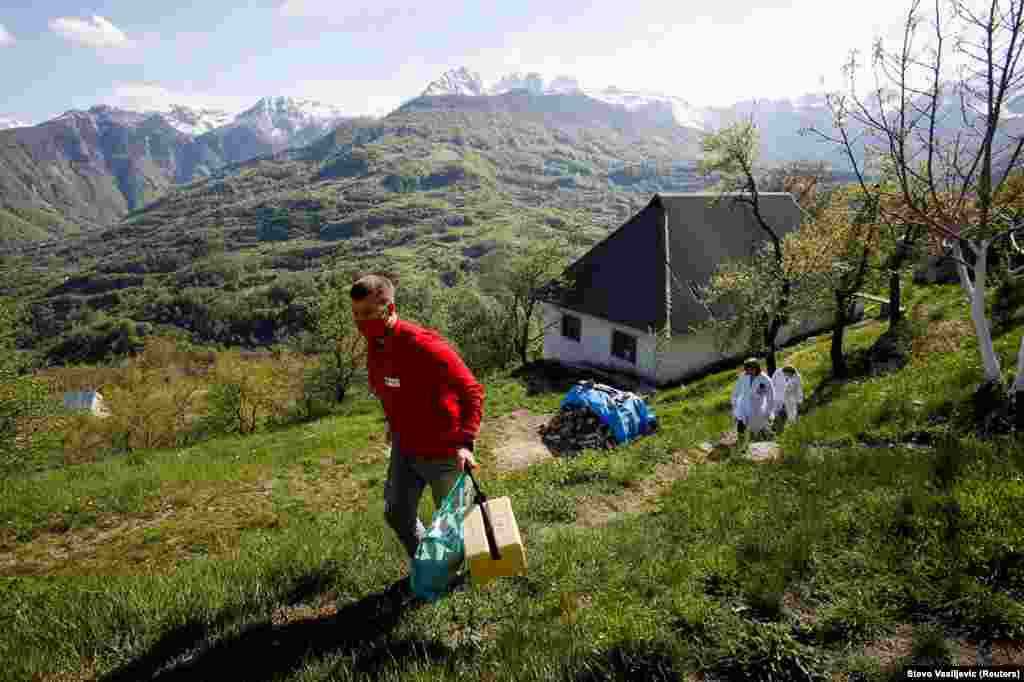 A Red Cross volunteer carries vaccine doses through the mountain village.&nbsp; The European Union has been criticized by some politicians in the Balkans for not providing greater aid to the region -- including to candidate and other nonmember countries -- when help was needed the most during the pandemic.&nbsp;