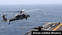 AT SEA -- An MH-60S Sea Hawk lands on the flight deck of USS Boxer (LHD-4) in the Arabian Sea off Oman, July 16, 2019