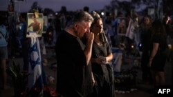 Relatives and other mourners of Israeli victims attend a ceremony at the Nova memorial near Kibbutz Reim in southern Israel on the first anniversary of the October 7, 2023, attack by Hamas.