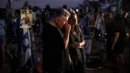 Relatives and other mourners of Israeli victims attend a ceremony at the Nova memorial near Kibbutz Reim in southern Israel on the first anniversary of the October 7, 2023, attack by Hamas.