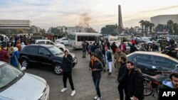 People celebrate on Umayyad Square in Damascus on December 8 after rebel forces claimed to have ousted President Bashar al-Assad. 