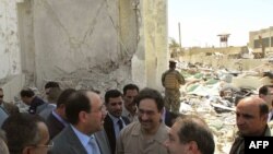 Iraqi Foreign Minister Hoshyar Zebari (second from right) speaks to Prime Minister Nuri al-Maliki (second from left) as he surveys the damage following a truck bomb placed outside the Foreign Ministry building in Baghdad on August 24.