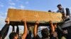 Iraqi mourners transport onto the roof of a vehicle the coffin of a person who was killed during clashes between anti-government protesters and security forces in the central holy Shi'ite shrine city of Najaf on November 28.