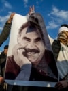 Supporters in Diyarbakir, Turkey, hold a banner of Kurdish leader Abdullah Ocalan as they celebrate his peace call on February 28.