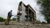 A man gestures toward a destroyed building on a poultry farm following shelling in the village of Karpaty in the Luhansk region of Russian-controlled Ukraine on May 31.